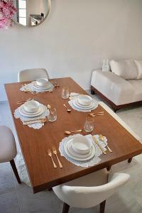 a dining room table with plates and glasses on it at Casa Cerezo in La Paz +10 photos