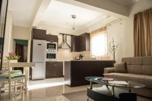 a kitchen and living room with a couch and a table at Konstan'shouse in Mytilene