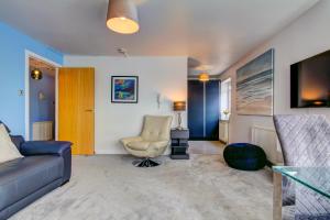 a living room with a couch and a chair at River Ayr View-Coorie Doon Stays in Ayr