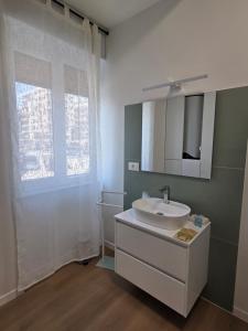 a bathroom with a sink and a mirror and a window at Nakupenda B&B in Cosenza +15 photos