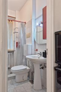 a white bathroom with a toilet and a sink at Leonardo apartment in Venice