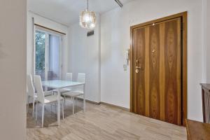 a dining room with a table and a wooden door at Leonardo apartment in Venice +30 photos
