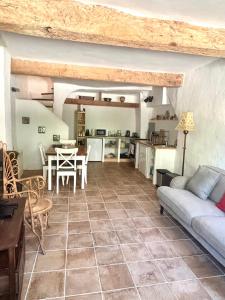 a living room with a couch and a table at Logement entier dans les Corbières in Coustouge
