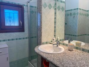 a bathroom with two sinks and a glass shower at Casa Marika in Murta Maria +18 photos