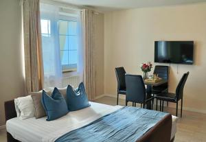 a hotel room with a bed and a table with chairs at Royal Villas in Prague