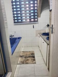 a bathroom with a blue sink and two sinks at Alena's Guesthouse in Durban
