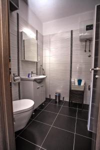 a bathroom with a toilet and a sink at Apartments Nevistic in Podstrana +58 photos