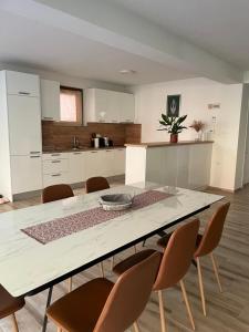 a large kitchen with a table and chairs at Villa Bella Una - Prizemlje in Cazin +13 photos