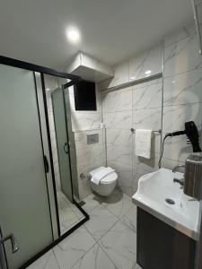 a bathroom with a toilet and a shower and a sink at Sara Suit in Istanbul