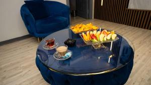 a blue coffee table with a tray of fruit on it at Sara Suit in Istanbul