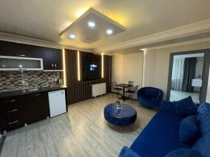 a living room with a blue couch and a table at Sara Suit in Istanbul +48 photos