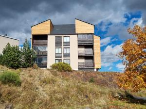 a house on top of a hill at Appartement en residence in Les Angles