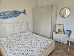 a bedroom with a bed with a fish on the wall at Casa VITTORIA in Procchio