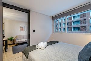 Uma cama ou camas num quarto em Corazón Stgo Estilo Puro