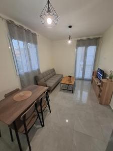 a living room with a couch and a table at Xrisa Apartments in Petalidi