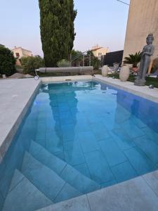 a swimming pool with blue tiles on the floor at Le studio de Chloé en Provence in Fourques