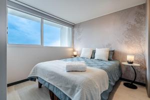Uma cama ou camas num quarto em Corazón Stgo Estilo Puro