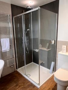 a glass shower in a bathroom with a toilet at Ronebhal Guest House in Oban +36 photos