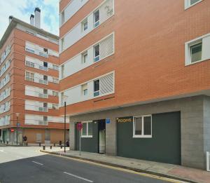an empty street in front of a building at Bilbao ROOMS Lidon in Bilbao