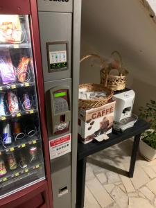 a refrigerator filled with drinks and a table with a box at Secret Villa in Vlorë