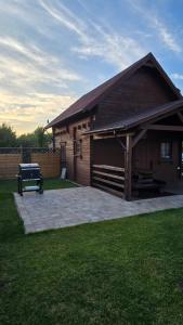 a house with a grill in front of it at Domek Wałowa 21 in Rewa