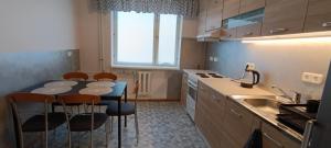 a kitchen with a table and chairs and a sink at Kapteni kodu in Paldiski