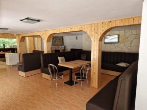 a dining room with a table and a couch at Mountain FIsh in Bicaz +7 photos