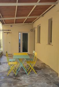 a patio with a table and two chairs at Pixel Sea Home a Misano Brasile 300 m dal mare e free parking, Misano World Circuit a 7 minuti di macchina in Misano Adriatico