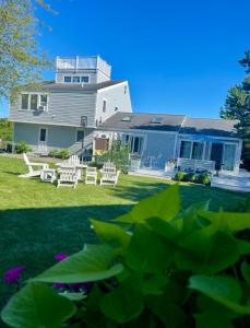 a house with white chairs and a yard at Katama Family Fun in Edgartown
