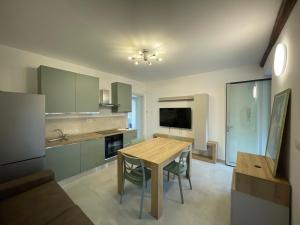 a kitchen with a wooden table and a dining room at Appartamenti Trillionaire in Rivoli