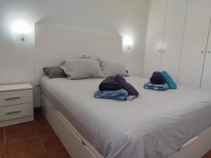 a bedroom with a bed with two towels on it at Horizon Views - Excellent location with ocean view in Puerto Rico de Gran Canaria +25 photos