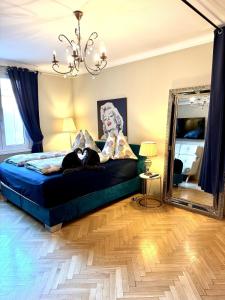 a dog laying on a bed in a bedroom with a mirror at Central View Vienna 92 sq m 3 BD apartment in Vienna