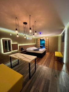 a room with a bed and a table in it at Mais Hotel in Água Boa