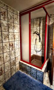 a bathroom with a red window and a sink at RuheUndSonne Apartment in Lichtenau