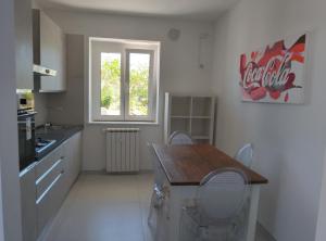a kitchen with a table and chairs and a window at Villa Antonina 2 in Crecchio