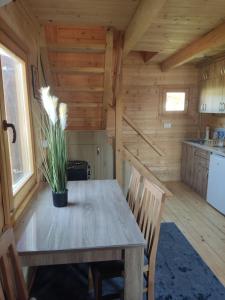 a dining room with a table in a log cabin at Kuća Pored Sunca in Kruševac