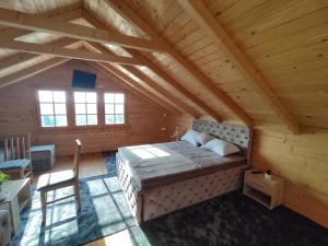 a bedroom with a bed in a wooden cabin at Kuća Pored Sunca in Kruševac +7 photos