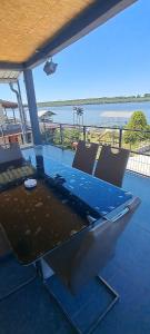 a table on a patio with a view of the water at Sobe i apartmani "Terasa" in Smederevo