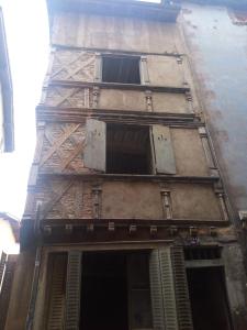 a tall building with windows on the side of it at Guest House in Riom
