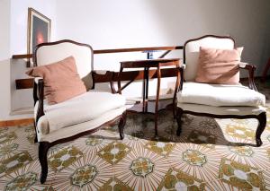 two chairs and a table in a room at Domus Santa Maria in Narni