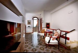a woman sitting in a chair in a living room at Domus Santa Maria in Narni