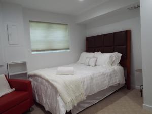 a bedroom with a large bed and a red chair at 9 Bedroom 6 Bath - Entire House in Alexandria +77 photos
