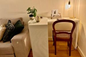 a living room with a couch and a chair at L'écrin du 12- Studio élégant sur jardin avec parking in Paris