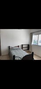 a bedroom with a bed and a window at Casa Vallarta in Jarretadera