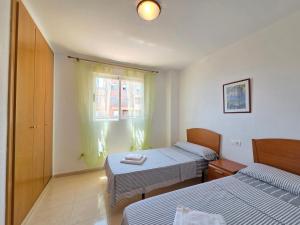 Postel nebo postele na pokoji v ubytování acapulco 3 frontal