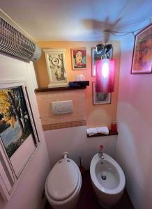 a bathroom with a white toilet and a sink at Grand Tour Suite Home in Spoleto +60 photos