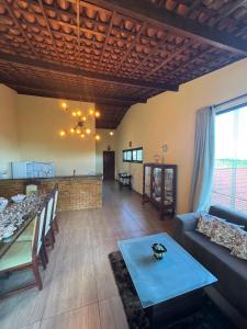 a living room with a couch and a table at Casa amarela Serra negra ! in Bezerros