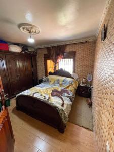 a bedroom with a large bed in a room at BEACHFRONT VUE SUR MER APPARt in Dar Merah Deriba