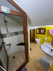 a bathroom with a sink and a shower and a toilet at BEACHFRONT VUE SUR MER APPARt in Dar Merah Deriba