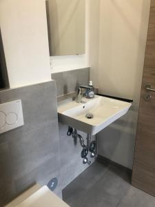a bathroom with a white sink and a mirror at Urban Stay & Style in Parsberg +4 photos
